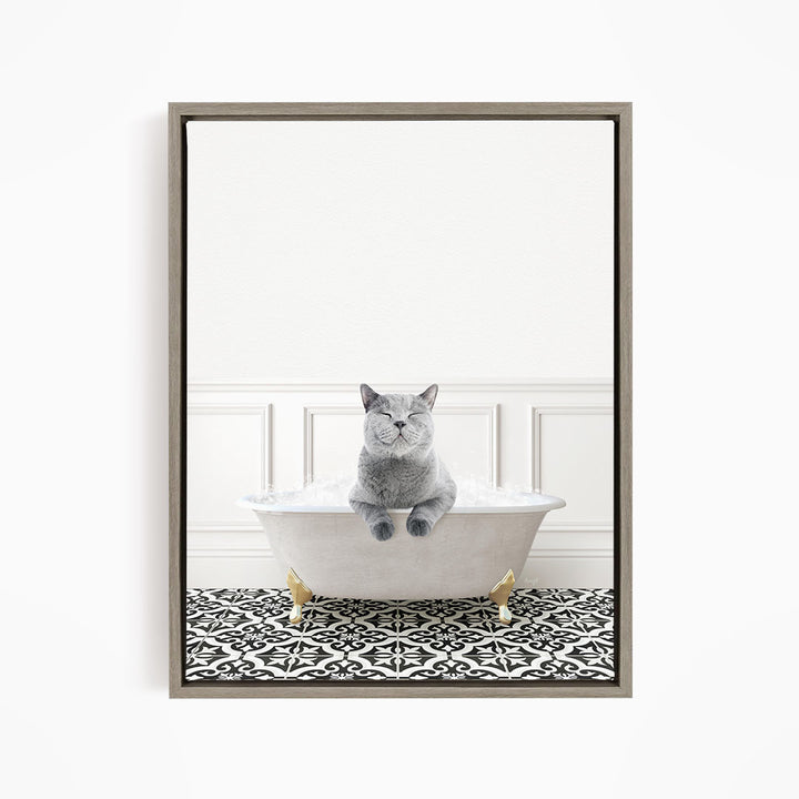 A gray cat sitting in a white bathtub filled with bubbles, with a black and white patterned floor in the background.