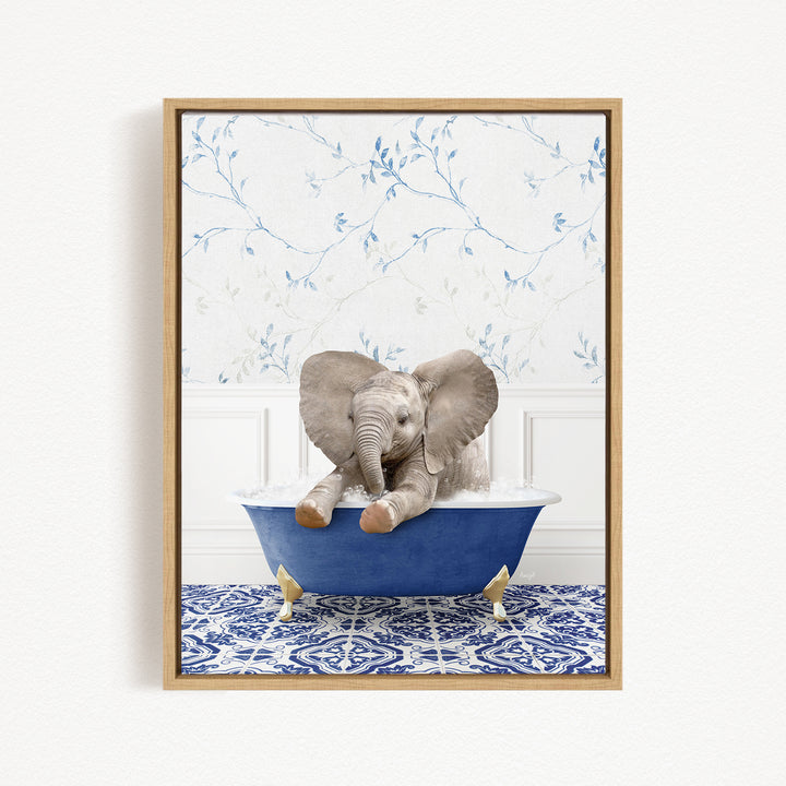 A baby elephant sitting in a blue bathtub, surrounded by a blue and white patterned rug and a floral wallpaper background.