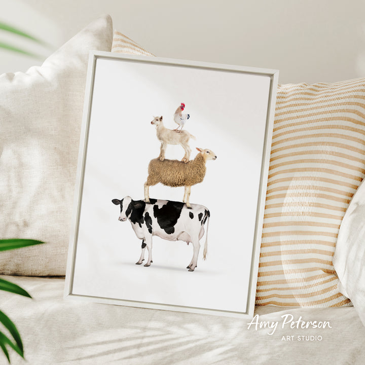 A framed illustration of a cow, sheep, and chicken stacked on top of each other, with a plant in the background.