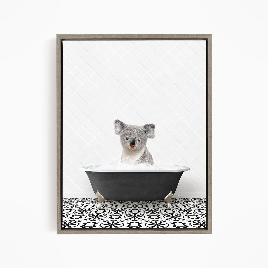 A koala bear sitting in a bathtub filled with water, looking directly at the camera.