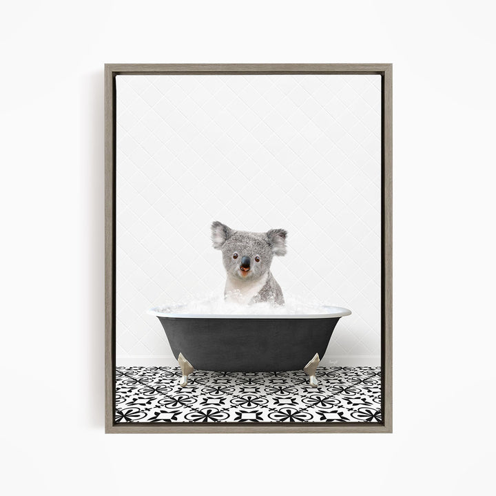 A koala bear sitting in a bathtub filled with water, looking directly at the camera.