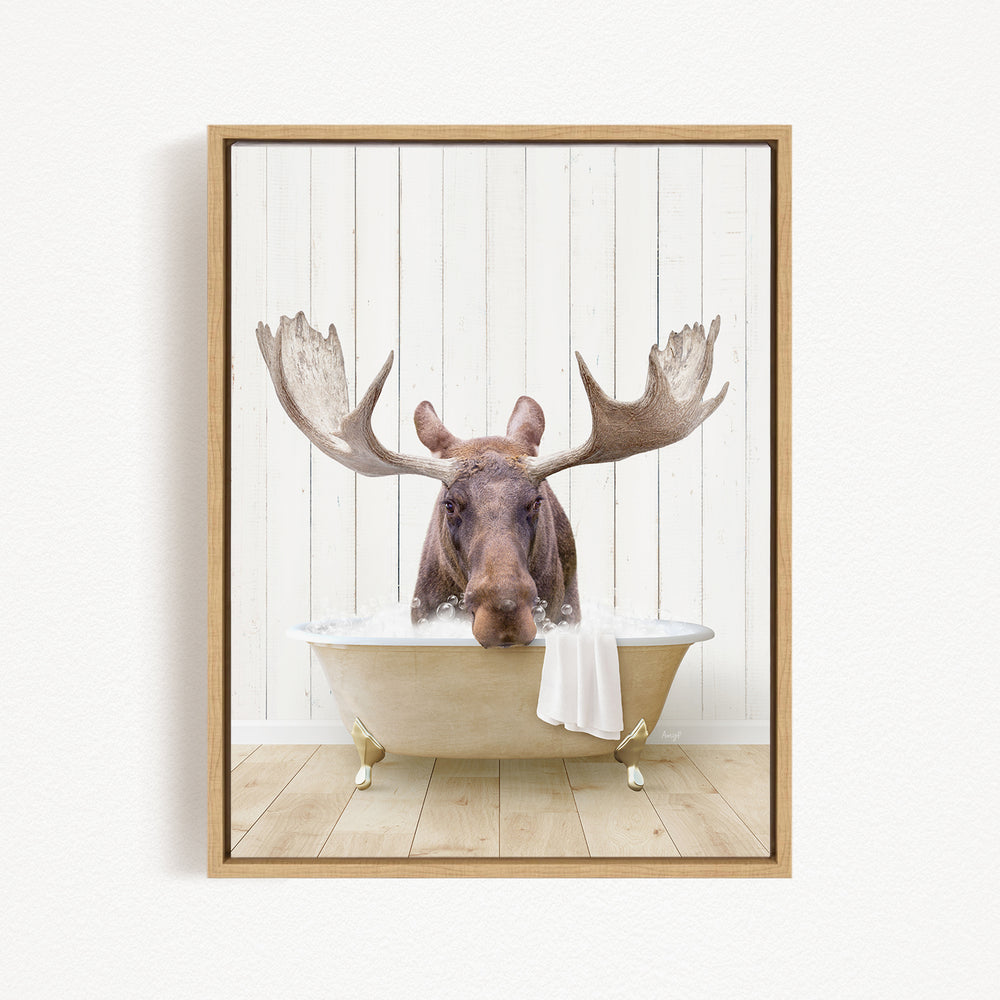 A moose with large antlers is sitting in a bathtub filled with water, creating a whimsical and humorous scene.