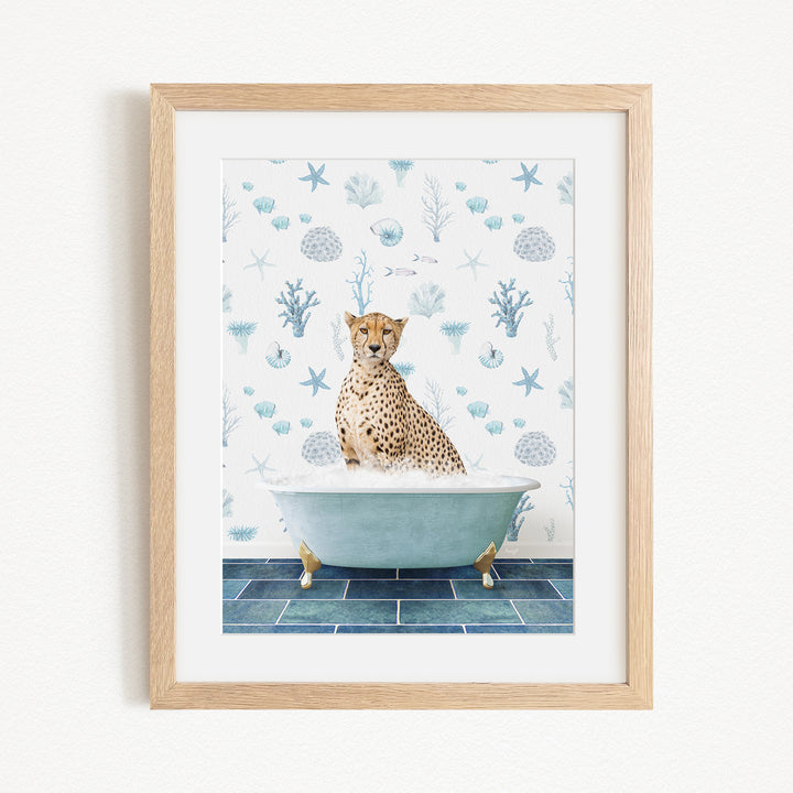 A cheetah sitting in a bathtub filled with water, surrounded by a blue and white ocean-themed wallpaper.