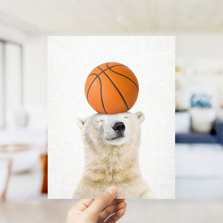 A polar bear balancing a basketball on its head.