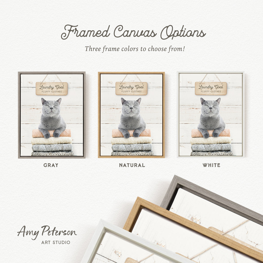 three framed canvas options, each featuring a gray cat sitting on a pile of laundry. The options include a gray frame, a natural frame, and a white frame.