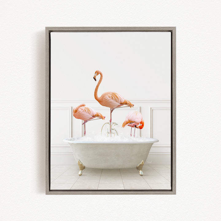 A framed image depicting three pink flamingos standing in a white bathtub filled with water.