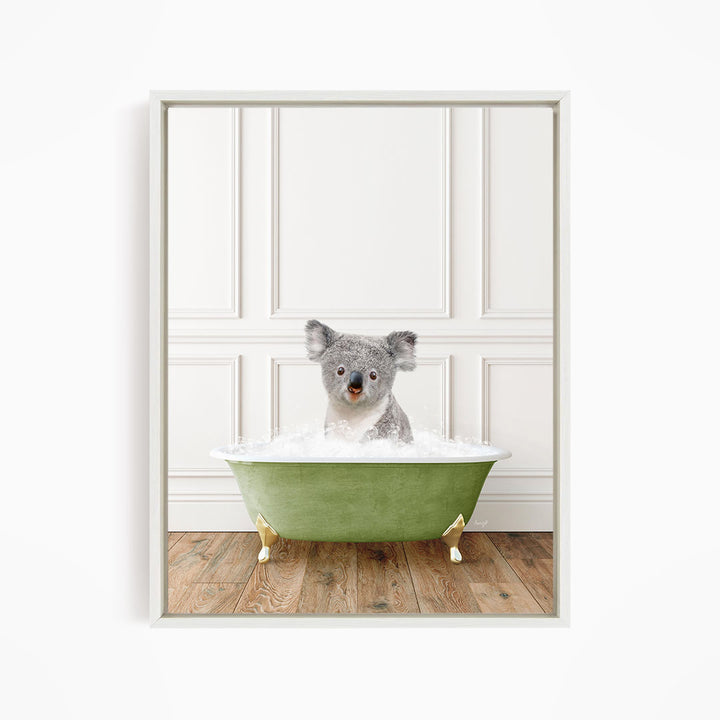 A koala bear sitting in a green bathtub filled with water, looking directly at the camera.
