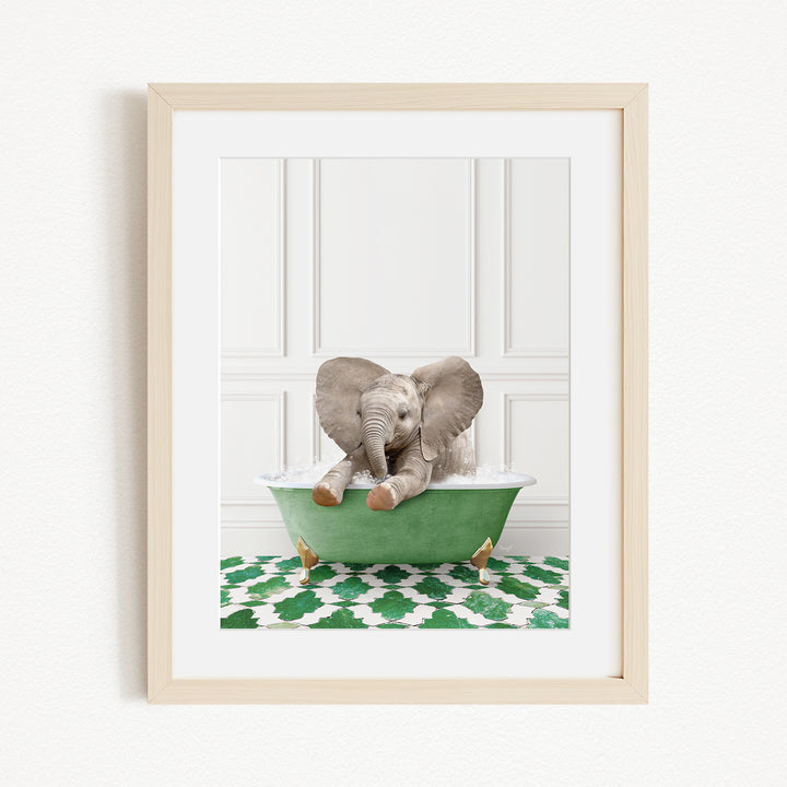 A baby elephant sitting in a green bathtub filled with water, surrounded by a green and white patterned rug.