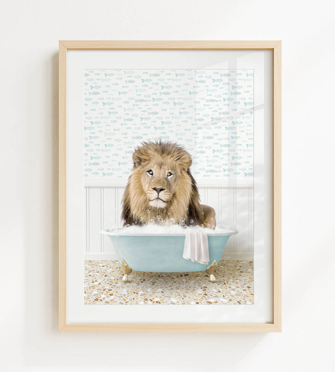 A lion sitting in a blue bathtub filled with bubbles, looking directly at the camera.