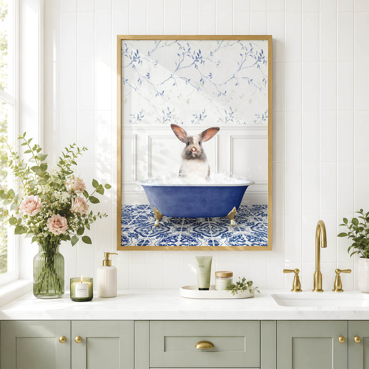 A framed image of a rabbit sitting in a blue bathtub, surrounded by flowers and a white and blue floral pattern on the wall.