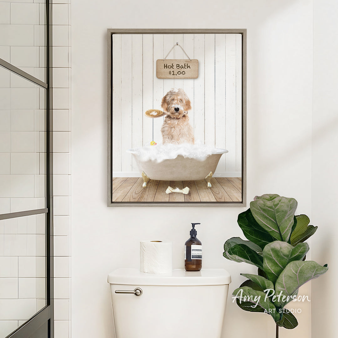 A framed image of a dog sitting in a bathtub, with a sign above it that says "Hot Bath is $10". The image also features a toilet and a potted plant in the bathroom.