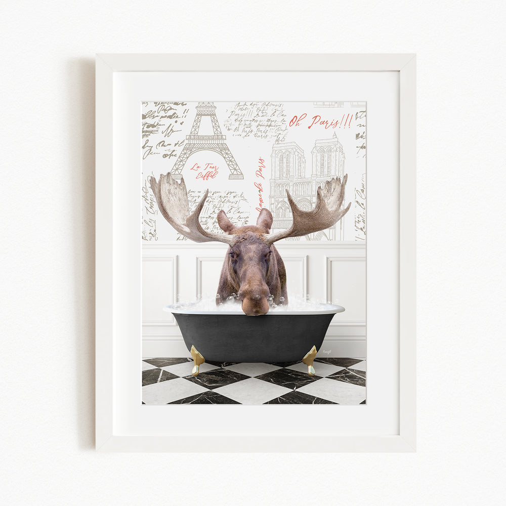 A moose is sitting in a bathtub, with a framed picture of the Eiffel Tower in the background.