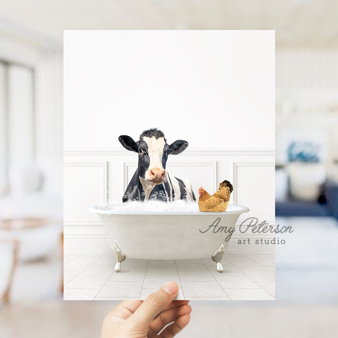 a hand holding up a card with a picture of a cow in a bathtub