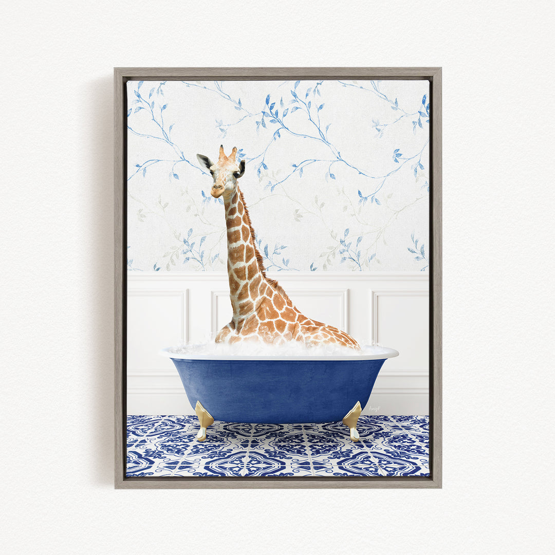 A giraffe sitting in a blue bathtub against a floral wallpaper background.