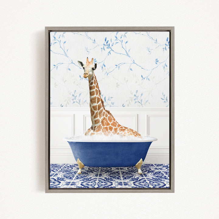 A giraffe sitting in a blue bathtub against a floral wallpaper background.