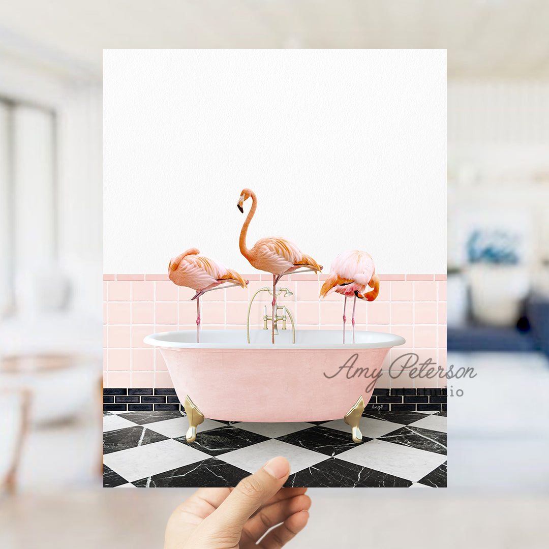 a person holding a card with flamingos in a bathtub