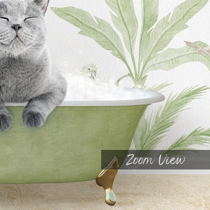 A gray cat sitting in a green bathtub, with a bird bath and palm leaves in the background.
