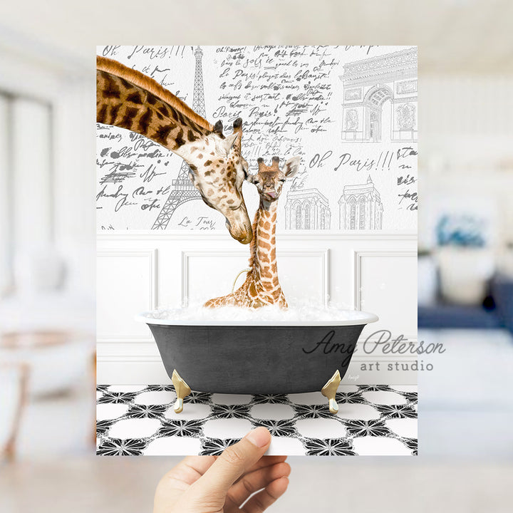 a person holding a card with a picture of two giraffes in a