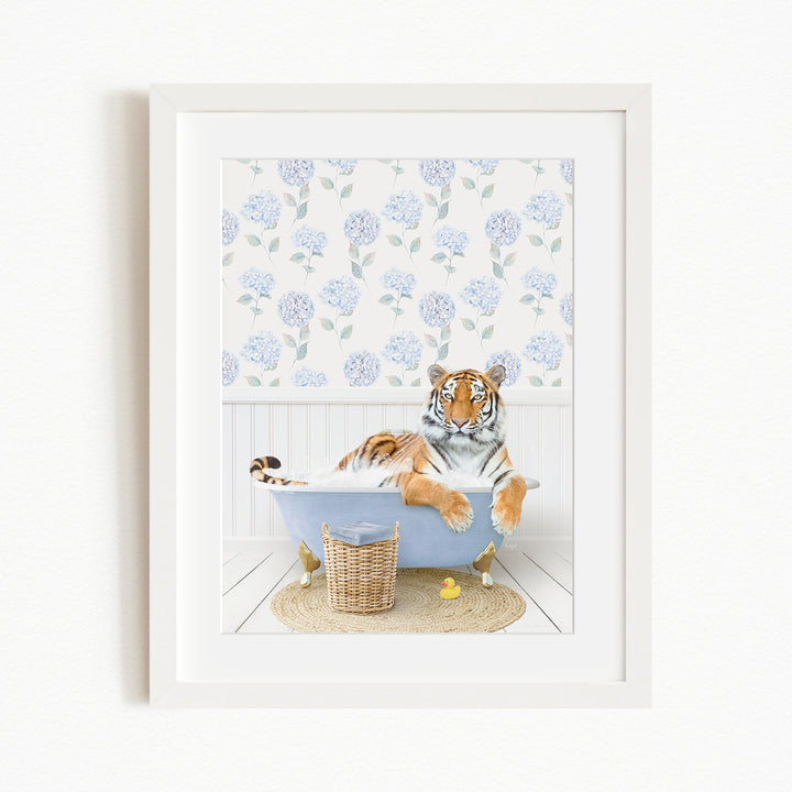 A tiger is sitting in a bathtub filled with water, surrounded by a blue floral pattern on the walls.