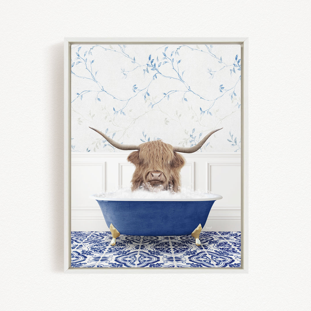 A brown cow with long horns is sitting in a blue bathtub, surrounded by a blue and white patterned rug and a white wall with blue floral wallpaper.