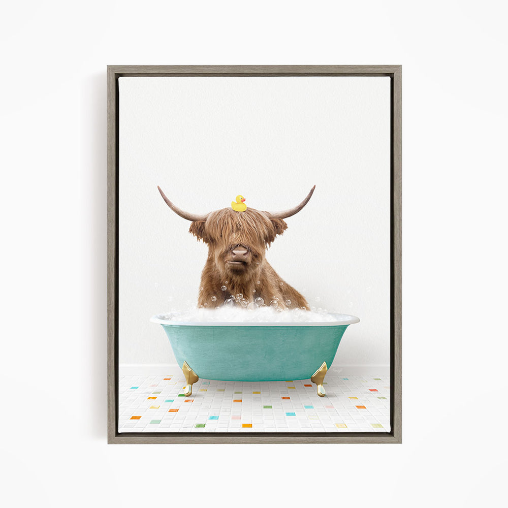 A brown cow with long horns is sitting in a blue bathtub filled with bubbles, with a yellow rubber duck perched on its head.