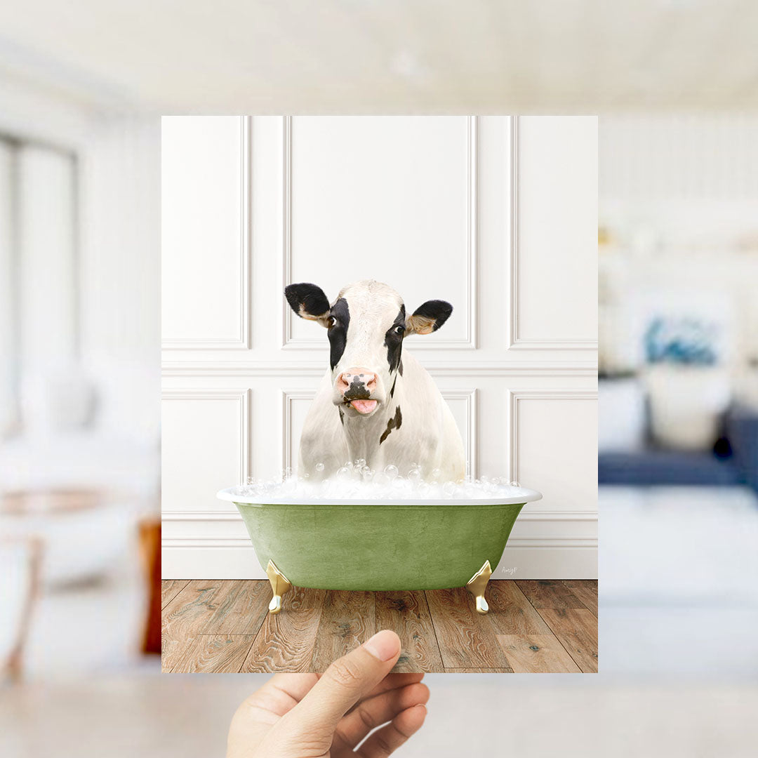 A cow is sitting in a green bathtub filled with water, with its head poking out of the tub.