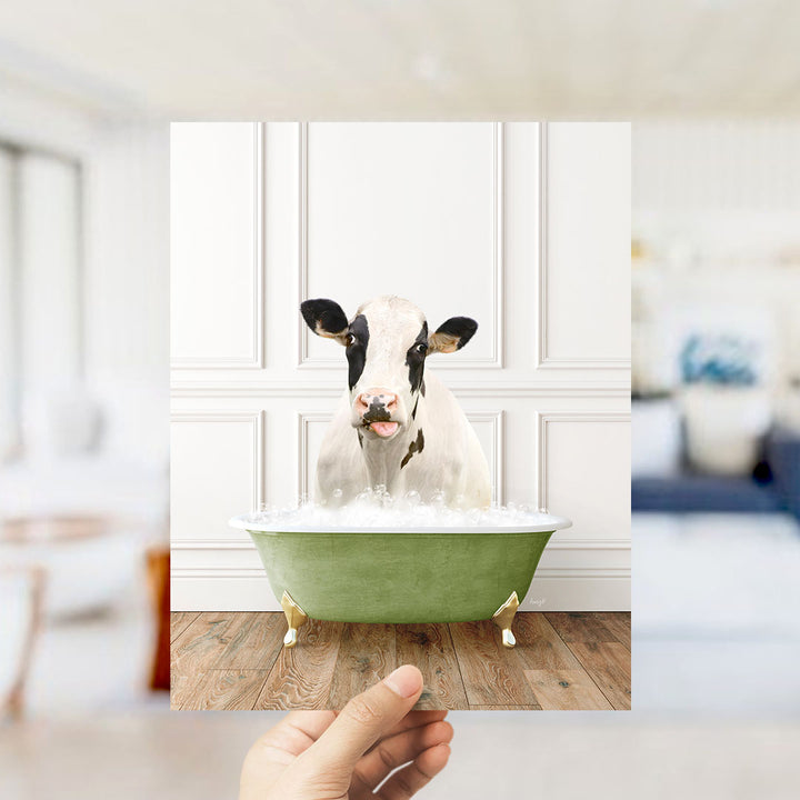 A cow is sitting in a green bathtub filled with water, with its head poking out of the tub.