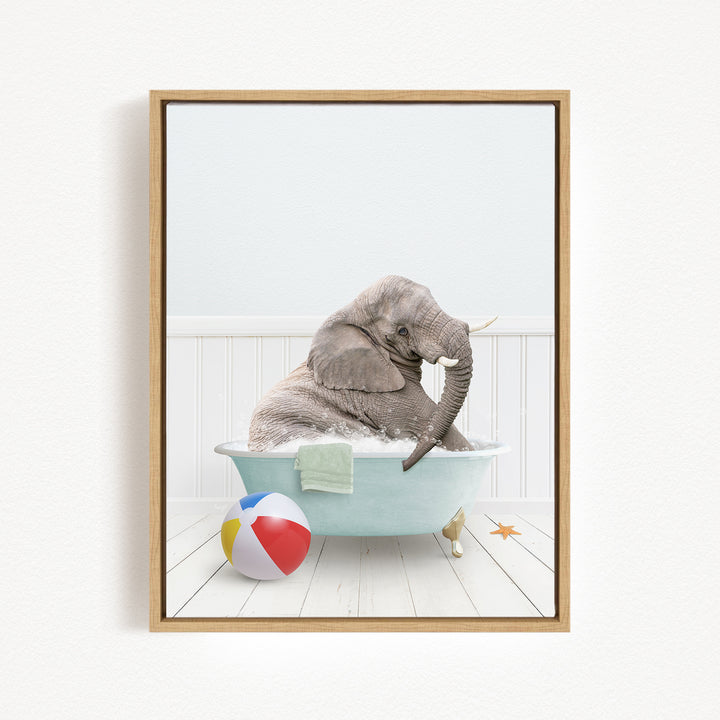 A gray elephant is sitting in a blue bathtub, surrounded by a beach ball and a starfish, creating a whimsical and playful scene.