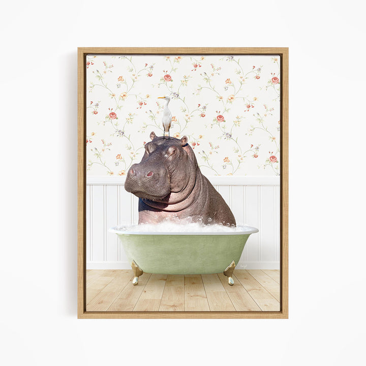A framed image depicting a hippopotamus sitting in a bathtub filled with water, with a bird perched on its head.