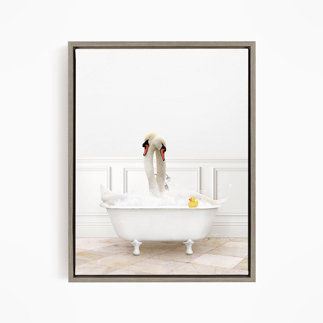 A white swan is sitting in a white bathtub, surrounded by bubbles, with a rubber duck floating nearby.