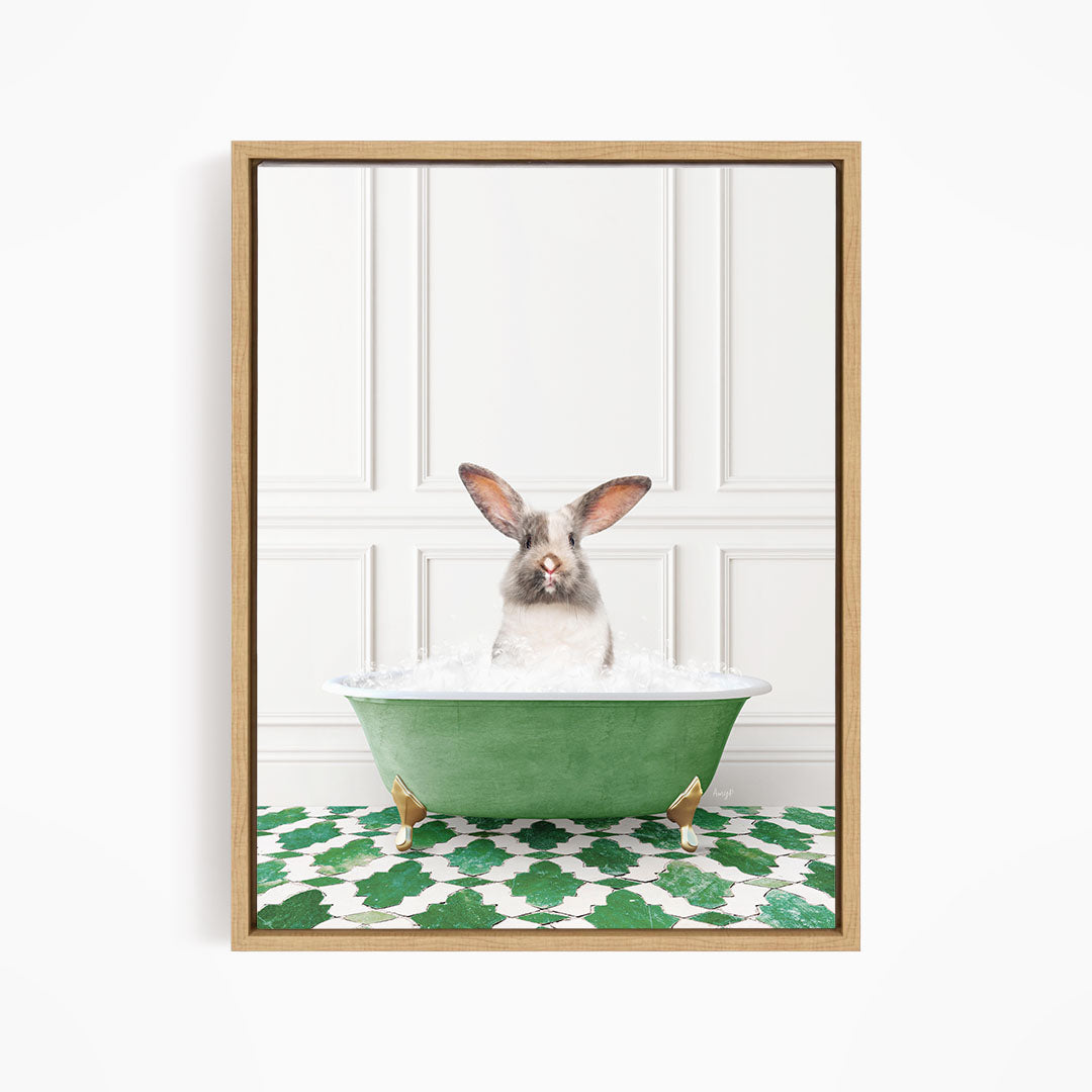 A white rabbit with brown ears is sitting in a green bathtub filled with water, looking directly at the camera.