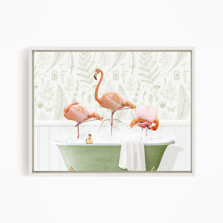 A framed image depicting three pink flamingos standing in a green bathtub filled with water, with a towel and a small rubber duck floating on the surface.
