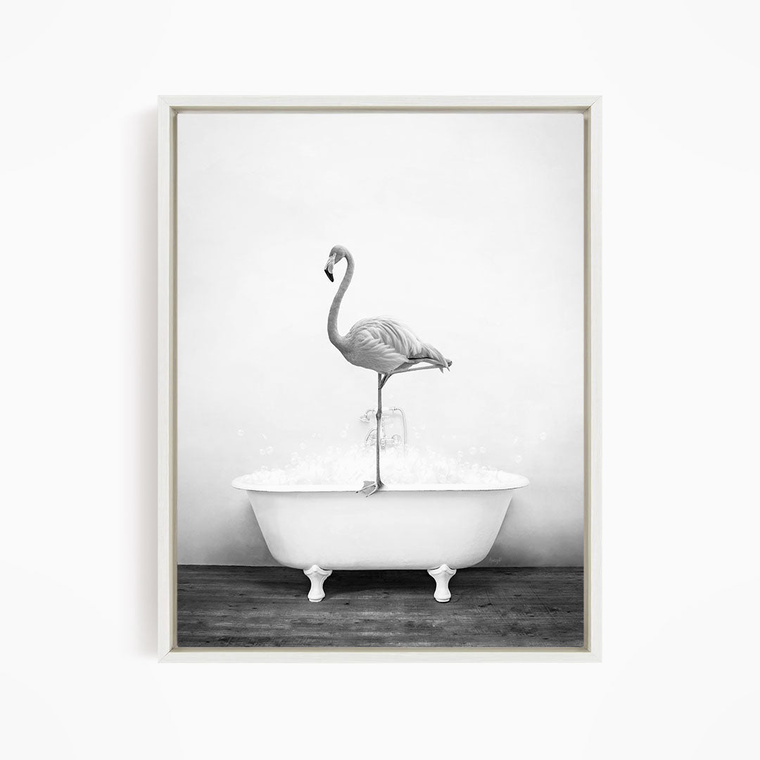 A flamingo standing on the edge of a white bathtub filled with water.