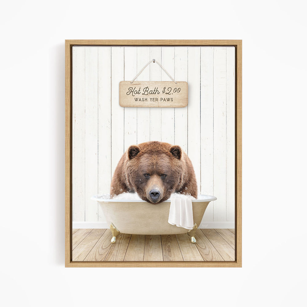 A brown bear relaxing in a bathtub, with a sign above the bear stating "Hot Bath $2.00 WASH YET Paws".
