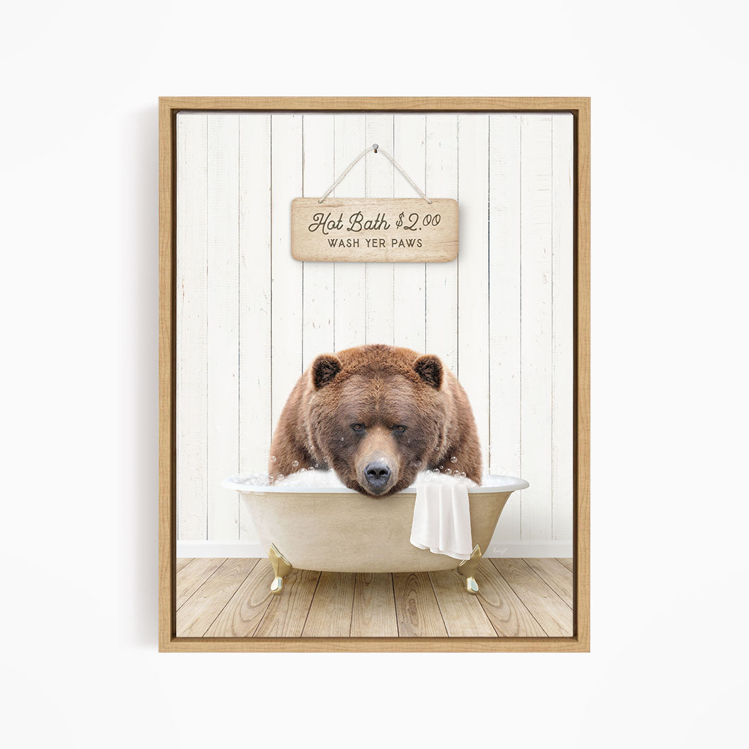 A brown bear relaxing in a bathtub, with a sign above the bear stating "Hot Bath $2.00 WASH YET Paws".