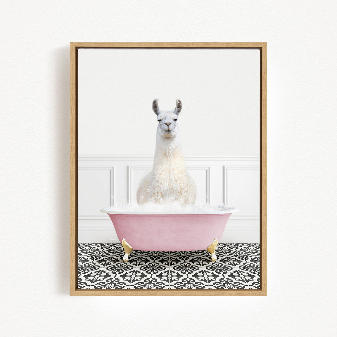 A white llama sitting in a pink bathtub filled with bubbles, with a black and white patterned floor in the background.
