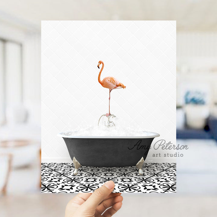 a person holding up a card with a flamingo in a bathtub