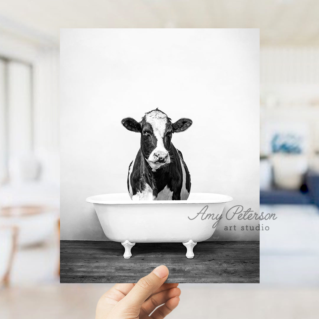 a black and white photo of a cow in a bathtub