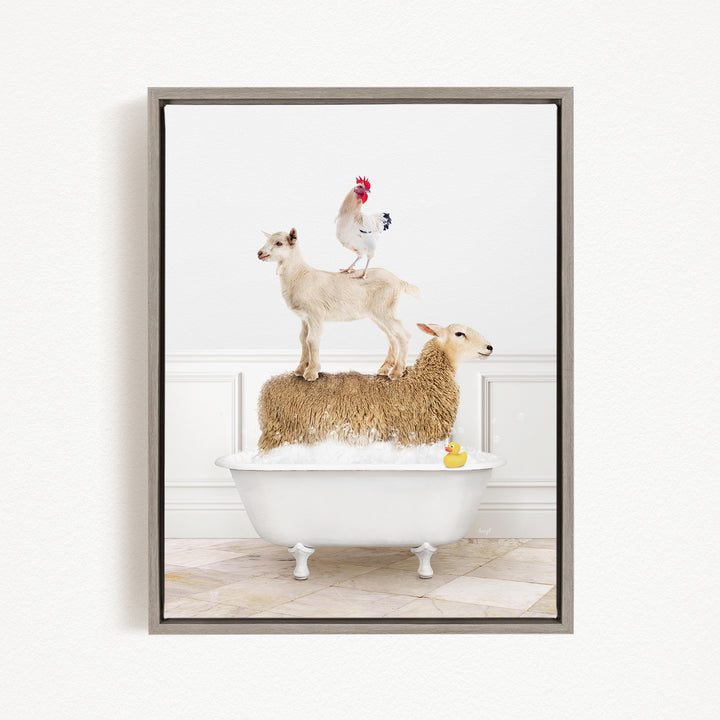 A framed image depicting a goat standing on top of a sheep in a bathtub, with a rooster perched on the sheep's back.