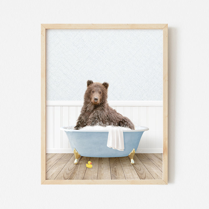 a brown bear sitting in a blue bath tub