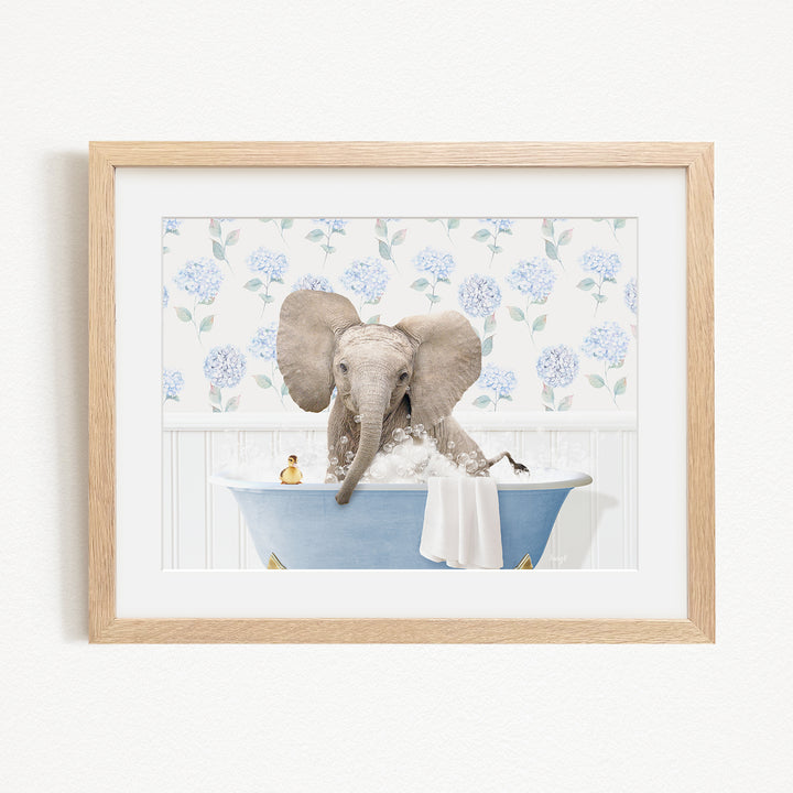 A baby elephant sitting in a blue bathtub, surrounded by a floral patterned wall.