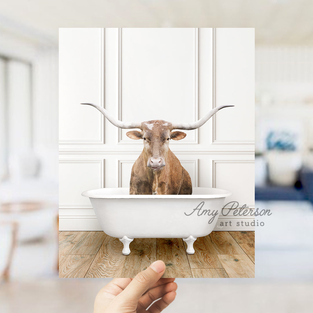 a cow sitting in a bathtub with long horns