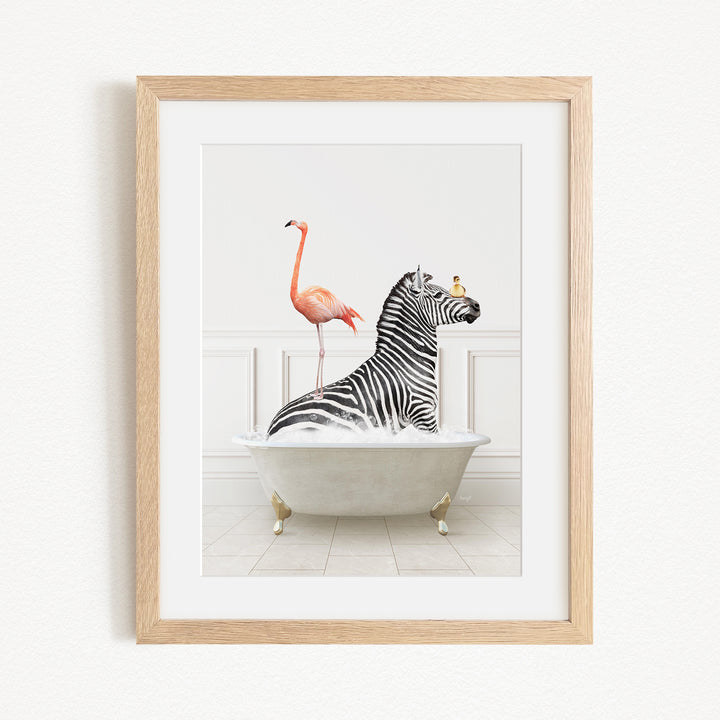 A framed image depicting a zebra sitting in a bathtub, with a flamingo standing on its back legs and a bird perched on its head.