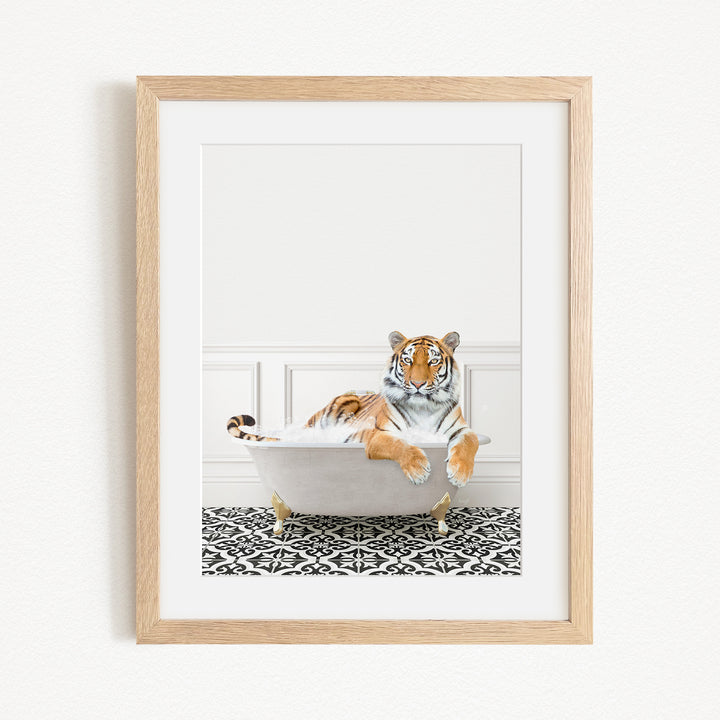 A tiger is sitting in a bathtub filled with bubbles, appearing relaxed and content.