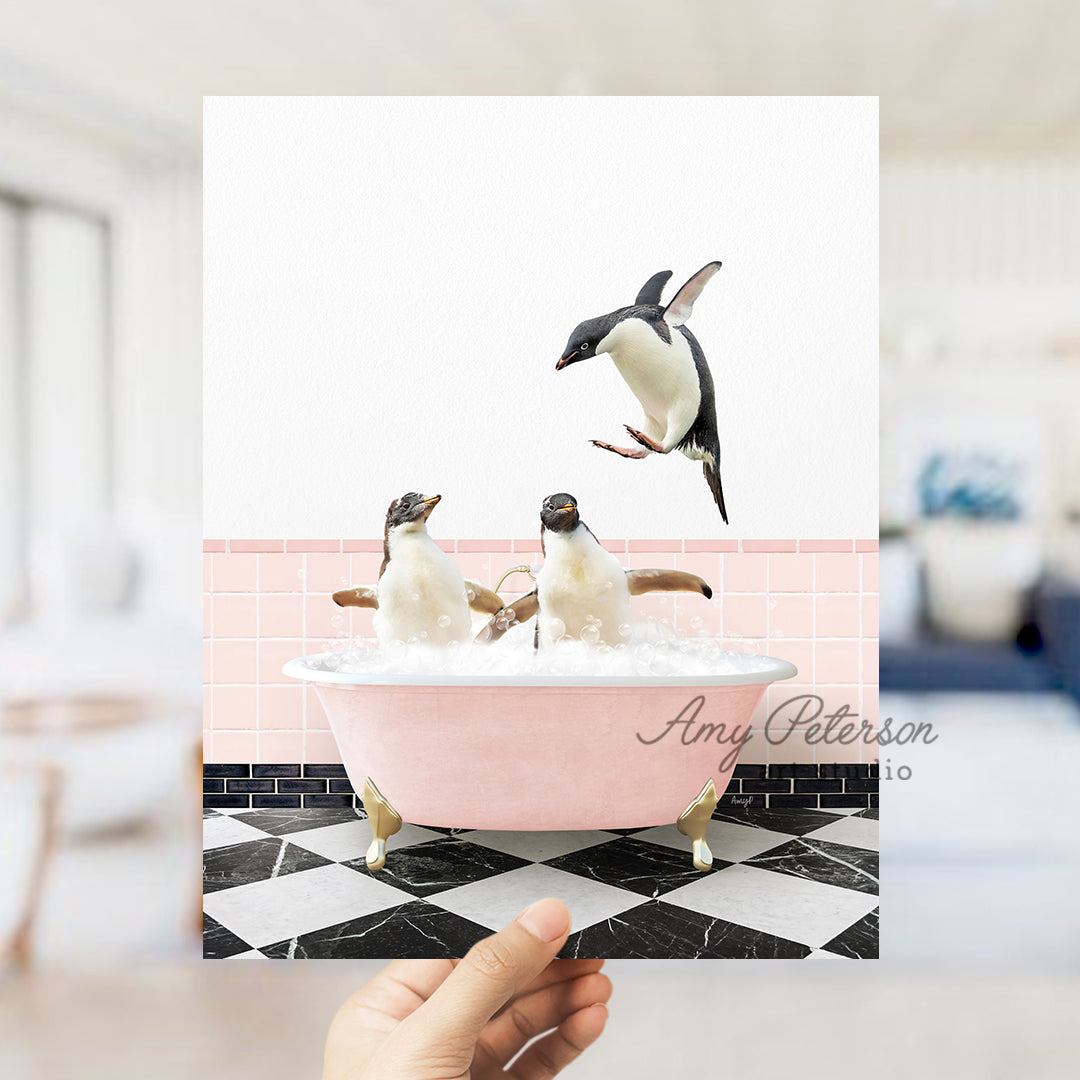 a person holding up a card with penguins in a bathtub