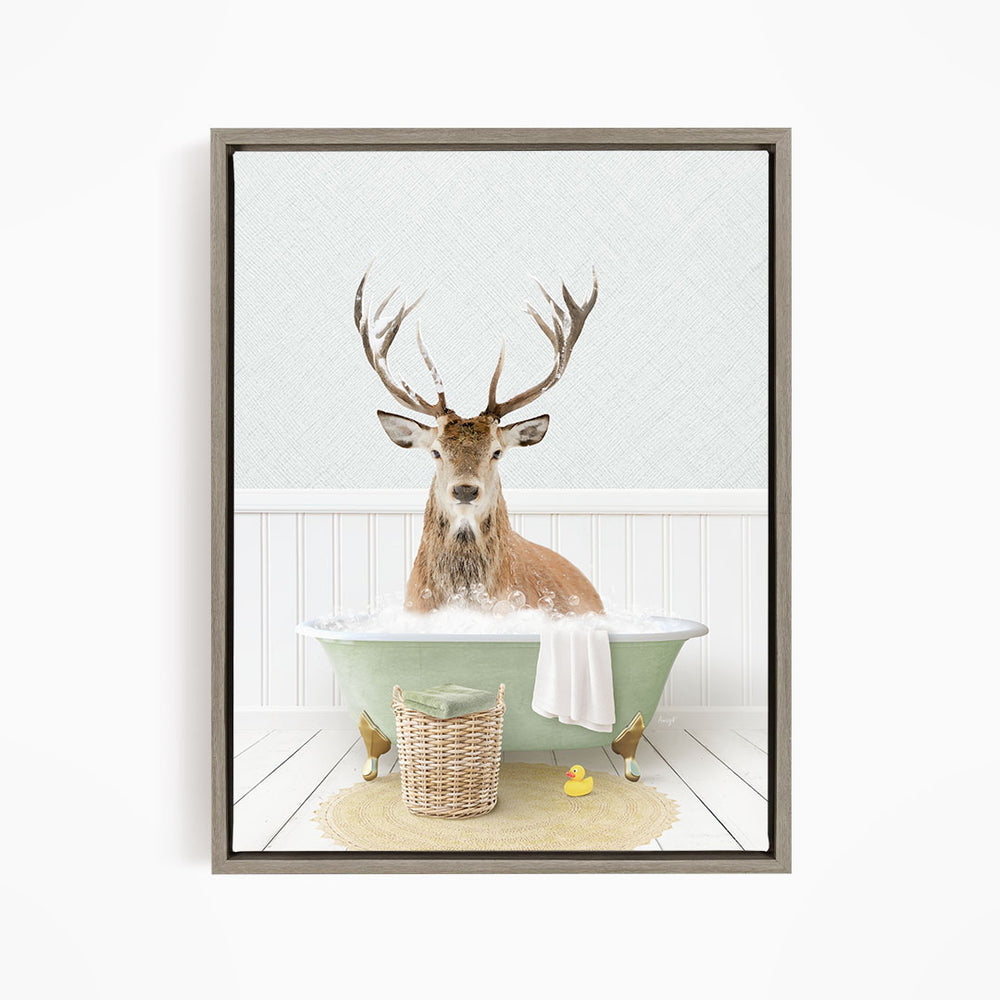A deer with large antlers is sitting in a green bathtub filled with bubbles, surrounded by a basket of toys and a yellow rubber duck.