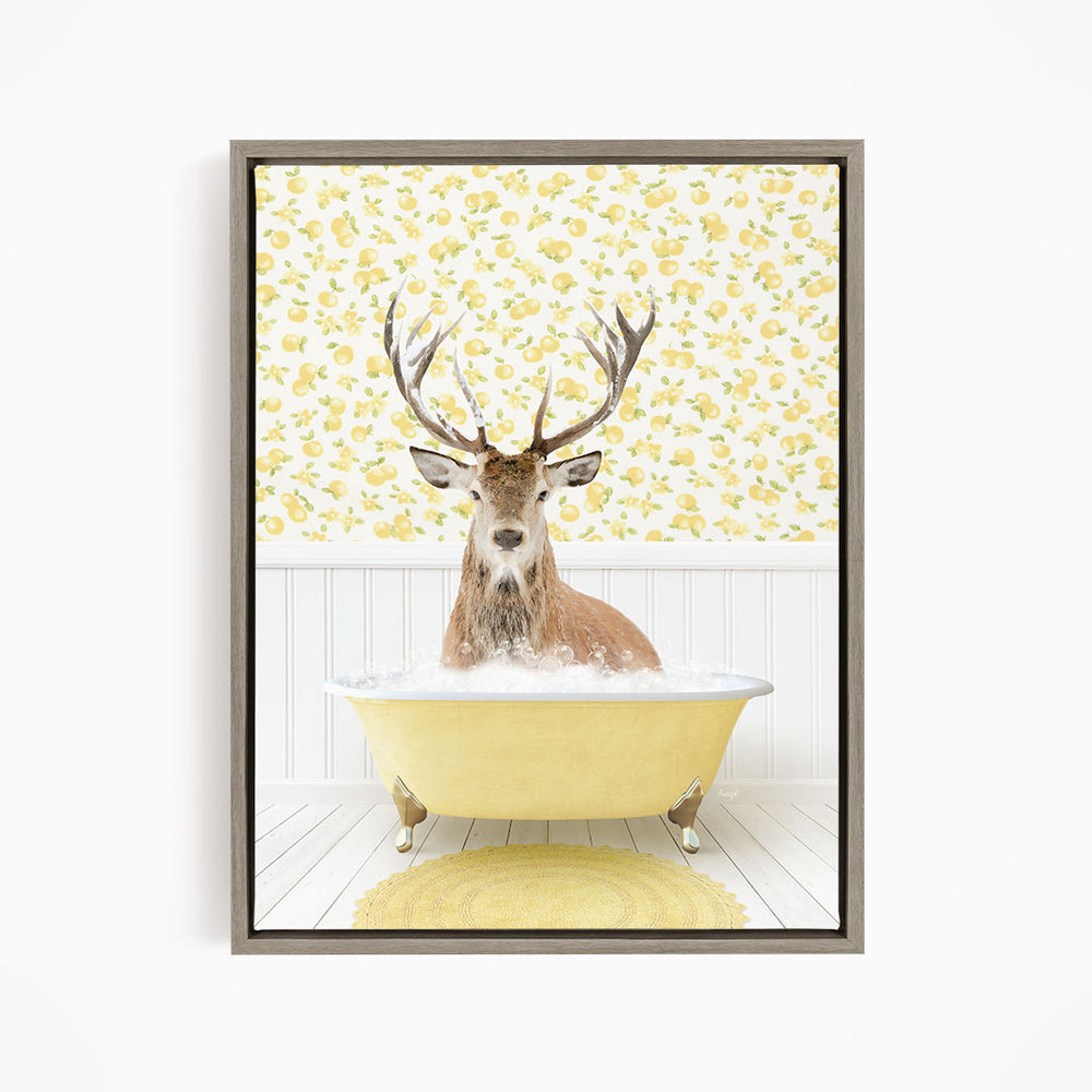 A deer with large antlers is sitting in a yellow bathtub, surrounded by a yellow and white floral patterned wall.