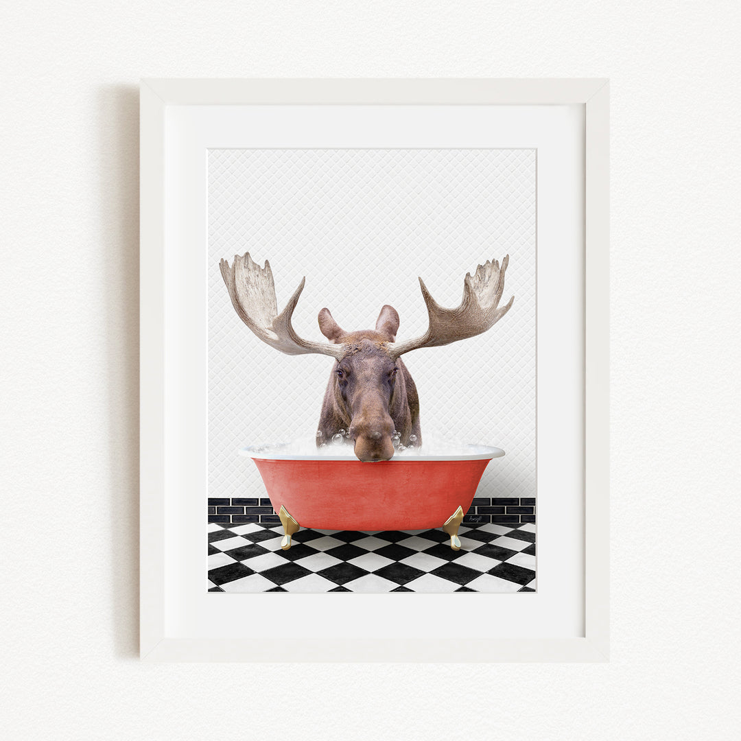 A moose with large antlers is sitting in a red bathtub, surrounded by a black and white checkered floor.