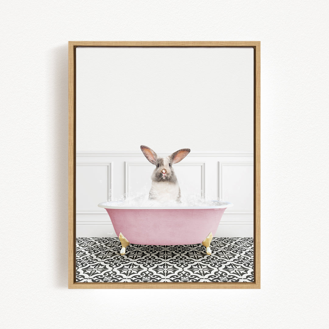 A gray and white rabbit sitting in a pink bathtub filled with water, surrounded by a black and white patterned floor.