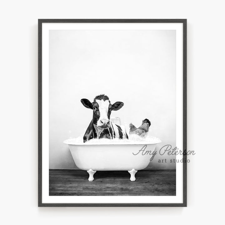 a black and white photo of a cow in a bathtub